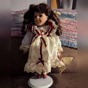 Charming Porcelain Doll With Cream and Cranberry Red Dress with Lace Details